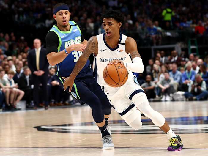 Mar 6, 2020; Dallas, Texas, USA; Memphis Grizzlies guard Ja Morant (12) drives in the second quarter against Dallas Mavericks guard Seth Curry (30) at the American Airlines Center.
