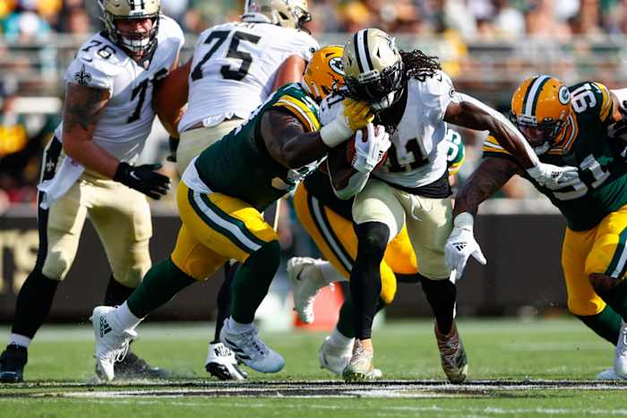New Orleans Saints running back Alvin Kamara (41) carries the ball as Green Bay tackle Kenny Clark (97) defends. Mandatory Credit: Nathan Ray Seebeck-USA TODAY Sports