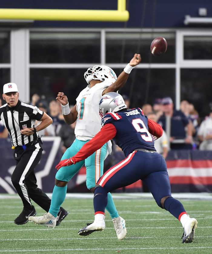Miami Dolphins quarterback Tua Tagovailoa (1) throws the ball prior to getting hit by New England Patriots linebacker Matt Judon (9). Mandatory Credit: Bob DeChiara-USA TODAY Sports