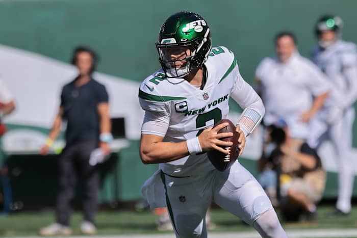 New York Jets quarterback Zach Wilson (2) rolls out during the second half against the New England Patriots at MetLife Stadium.