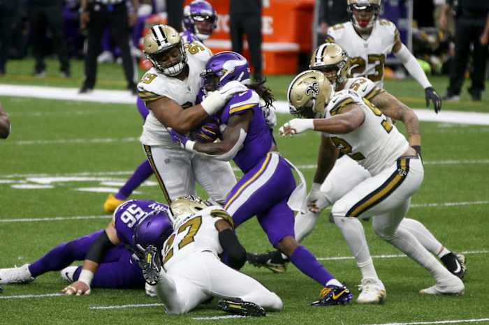 Minnesota Vikings running back Dalvin Cook (33) is tackled by New Orleans Saints defensive tackle Shy Tuttle (99) and safety Malcolm Jenkins (27). Mandatory Credit: Chuck Cook-USA TODAY Sports