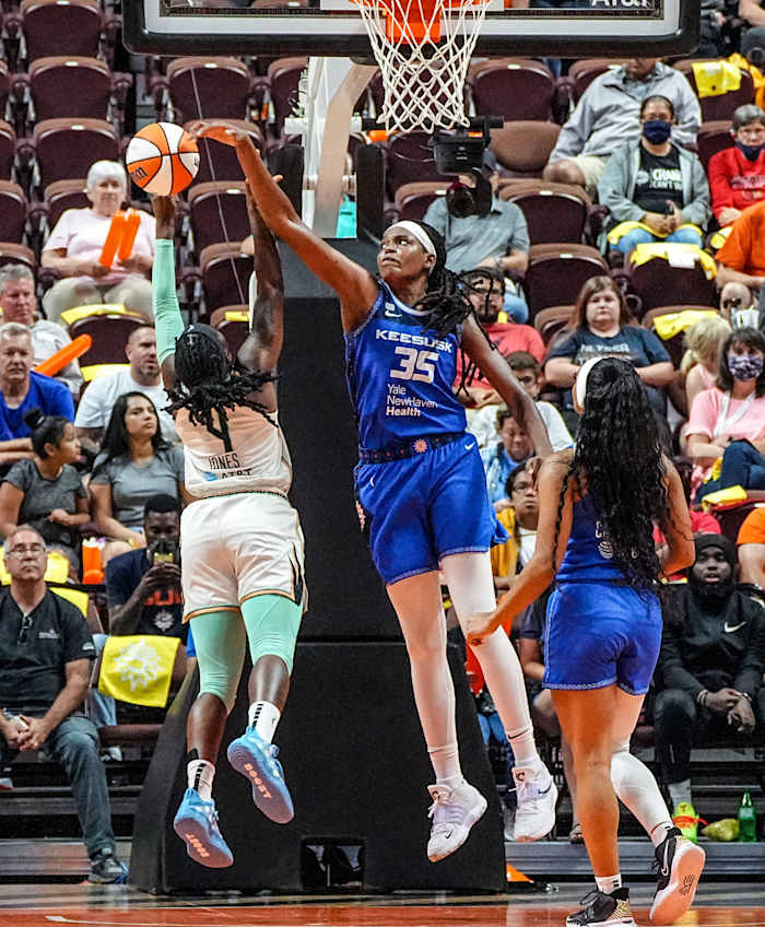 Jonquel Jones blocks a shot from the Liberty's Jazmine Jones