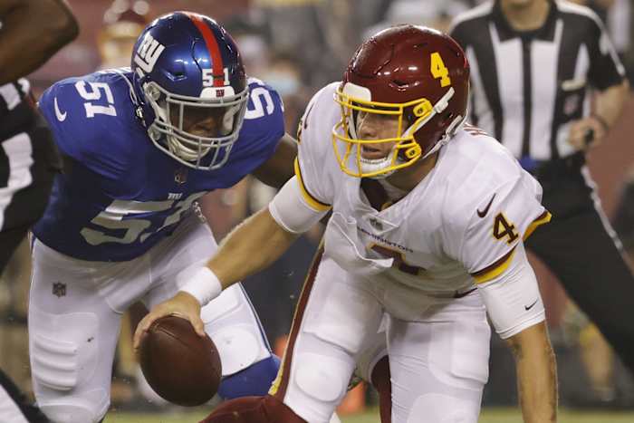 Sep 16, 2021; Landover, Maryland, USA; Washington Football Team quarterback Taylor Heinicke (4) is sacked by New York Giants linebacker Azeez Ojulari (51) in the first quarter at FedExField.