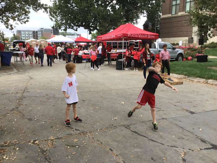 Boys toss a football at a tailgate on the west edge of the university campus before the Northwestern game.