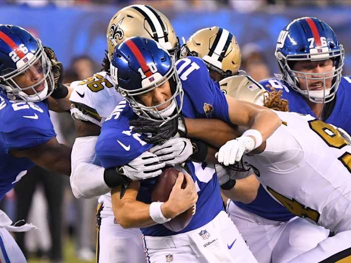 New York Giants quarterback Eli Manning (10) gets sacked by New Orleans Saints linebacker Demario Davis (56) and defensive end Cameron Jordan (94). Mandatory Credit: Robert Deutsch-USA TODAY