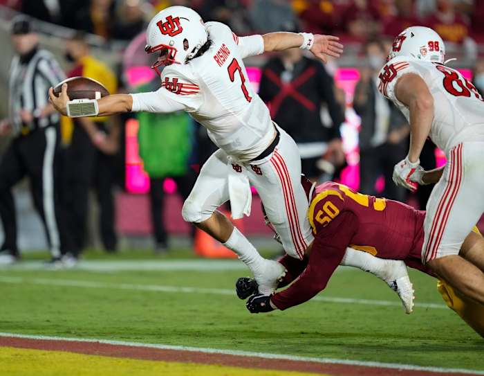 Utah quarterback Cameron Rising (7) dives into the end zone to score a third quarter touchdown.