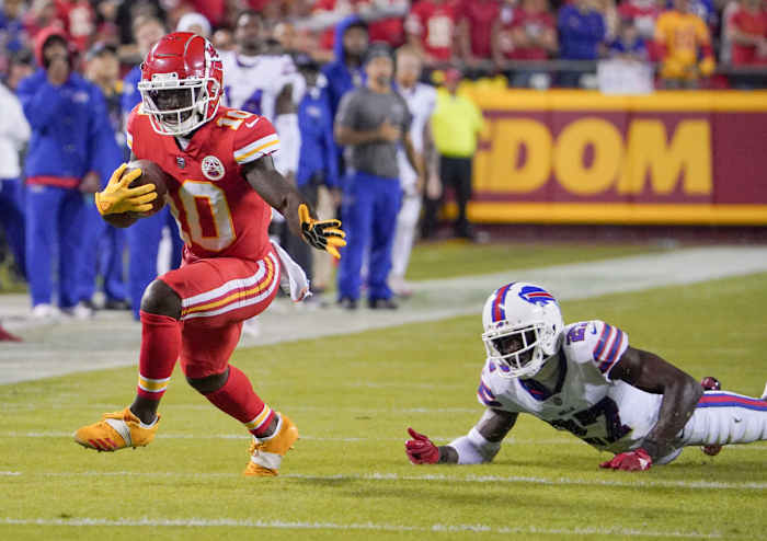 Oct 10, 2021; Kansas City, Missouri, USA; Kansas City Chiefs wide receiver Tyreek Hill (10) runs the ball as Buffalo Bills cornerback Tre'Davious White (27) misses the tackle during the first half at GEHA Field at Arrowhead Stadium. Mandatory Credit: Denny Medley-USA TODAY Sports
