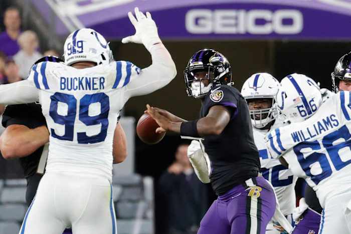 Oct 11, 2021; Baltimore, Maryland, USA; Baltimore Ravens quarterback Lamar Jackson (8) throws a touchdown pass to Baltimore Ravens wide receiver Marquise Brown (not pictured) under pressure from Indianapolis Colts defensive tackle DeForest Buckner (99) during the third quarter at M&T Bank Stadium. Mandatory Credit: Geoff Burke-USA TODAY Sports