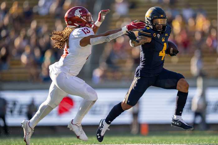 California Golden Bears wide receiver Nikko Remigio (4) runs against Washington State Cougars linebacker Jahad Woods (13) during the third quarter at FTX Field at California Memorial Stadium.