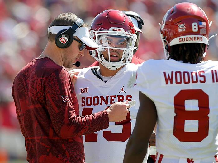 Oklahoma coach Lincoln Riley talks to QB Caleb Williams