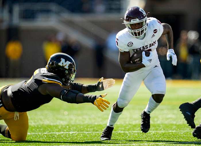Oct 16, 2021; Columbia, Missouri, USA; Texas A&M Aggies running back Devon Achane (6) runs against Missouri Tigers defensive lineman Darius Robinson (6) during the second half at Faurot Field at Memorial Stadium.