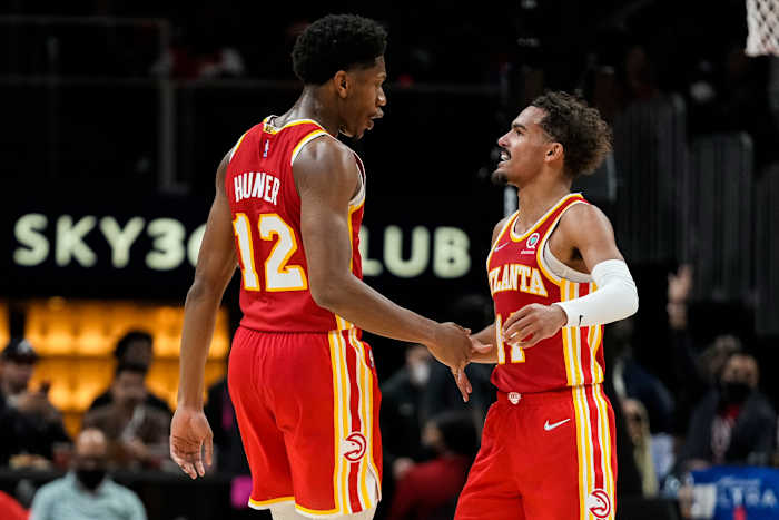 Atlanta Hawks forward De'Andre Hunter (12) shakes hands with guard Trae Young (11) after making a shot against the Dallas Mavericks during the second half at State Farm Arena.