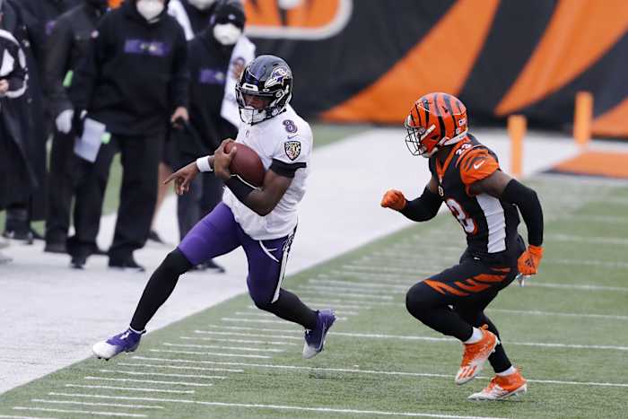 Jan 3, 2021; Cincinnati, Ohio, USA; Baltimore Ravens quarterback Lamar Jackson (8) defended by Cincinnati Bengals cornerback Darius Phillips (23) during the first quarter at Paul Brown Stadium. Mandatory Credit: Joseph Maiorana-USA TODAY Sports