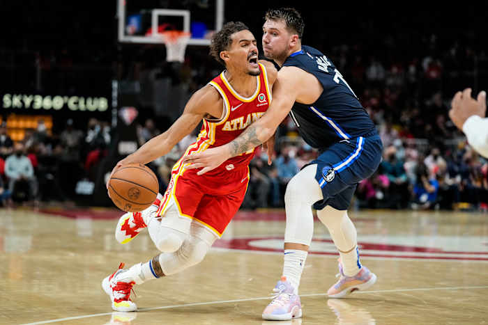 Atlanta Hawks guard Trae Young (11) dribbles against Dallas Mavericks guard Luka Doncic (77) during the second half at State Farm Arena.