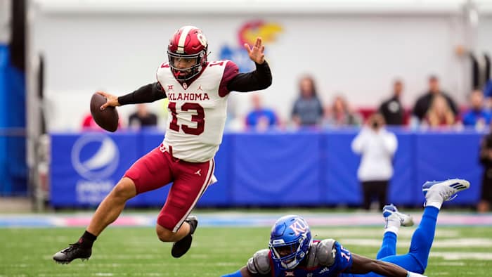 Oklahoma football's Caleb Williams escapes a Kansas defender.