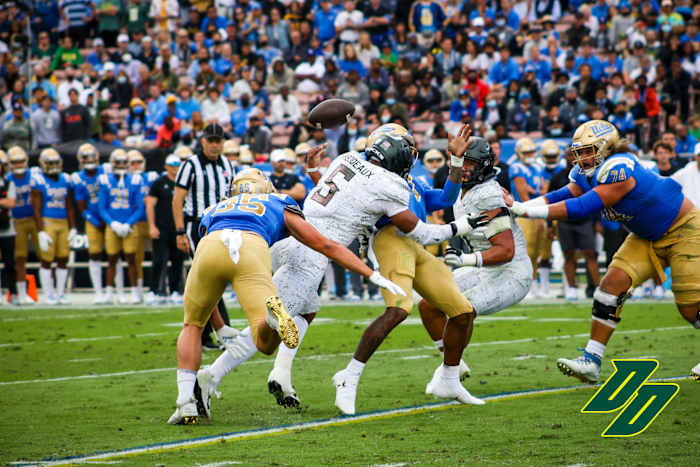 Kayvon Thibodeaux slams into UCLA quarterback Dorian Thompson-Robinson to force a fumble against the Bruins.
