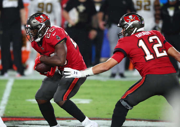 Tampa Bay quarterback Tom Brady (12) hands to running back Leonard Fournette (28) against the New Orleans Saints. Mandatory Credit: Kim Klement-USA TODAY Sports