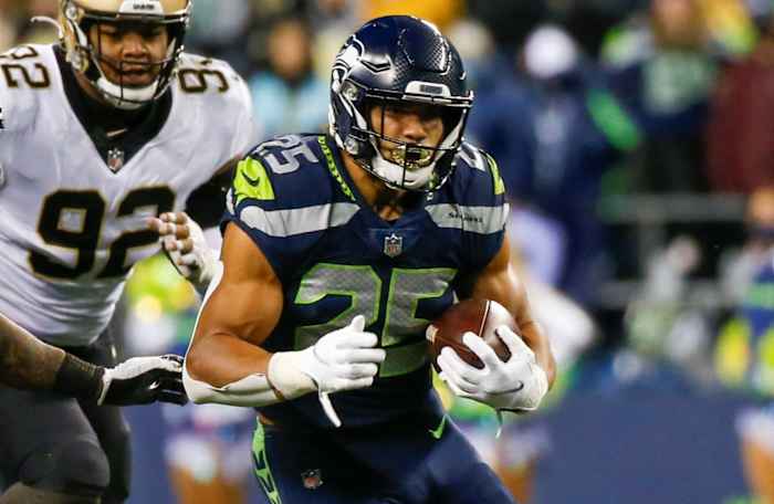 Seattle Seahawks running back Travis Homer (25) rushes against New Orleans Saints middle linebacker Kwon Alexander (5) during the third quarter at Lumen Field.