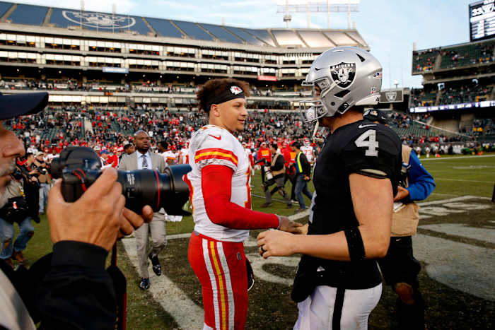 Dec 2, 2018; Oakland, CA, USA; Kansas City Chiefs quarterback Patrick Mahomes (15) meets with Oakland Raiders quarterback Derek Carr (4) after the game at Oakland Coliseum. Mandatory Credit: Cary Edmondson-USA TODAY Sports