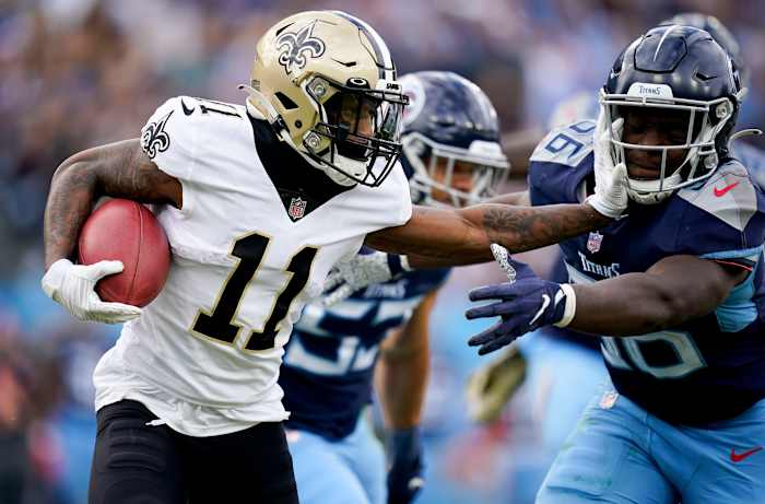 New Orleans Saints wide receiver Deonte Harris (11) keeps Tennessee Titans linebacker Monty Rice (56) at arms length during the second quarter at Nissan Stadium Sunday, Nov. 14, 2021 in Nashville, Tenn. Titans Saints 2558
