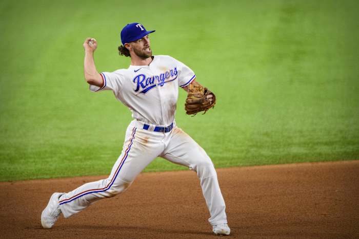Former Texas Rangers third baseman Charlie Culberson throws to first base during a game in 2021. Culberson is attempting to make the Atlanta Braves roster as a pitcher.