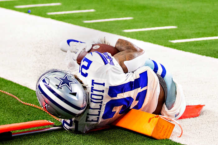 Ezekiel Elliott on the ground after falling on a first-down marker pylon cam