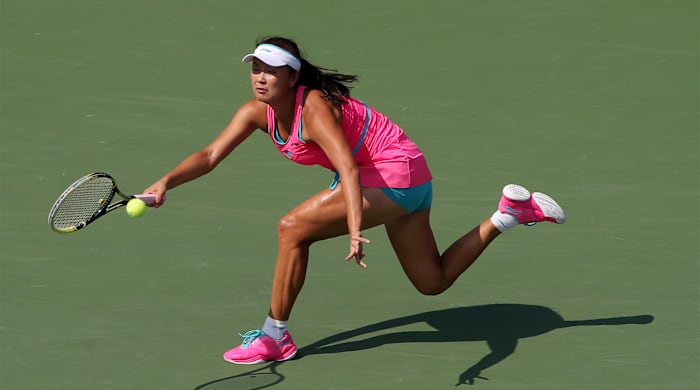 Sep 5, 2014; New York, NY, USA; Peng Shuai (CHN) returns a shot to Caroline Wozniacki (DEN) on day twelve of the 2014 U.S. Open tennis tournament at USTA Billie Jean King National Tennis Center.