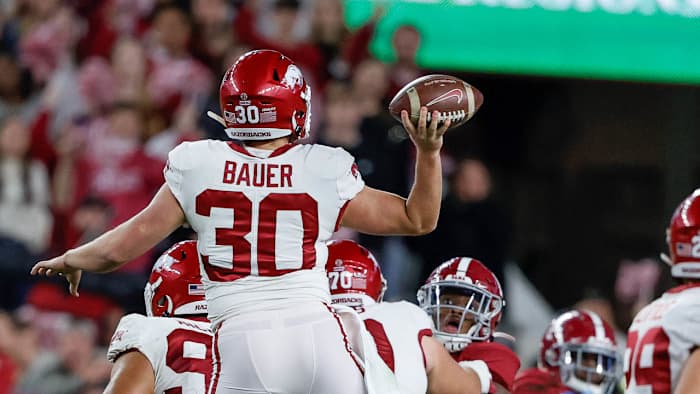 Razorbacks punter Reid Bauer throws a pass to tight end Blake Kern against Alabama on Nov. 12, 2021 in Tuscaloosa, Ala.