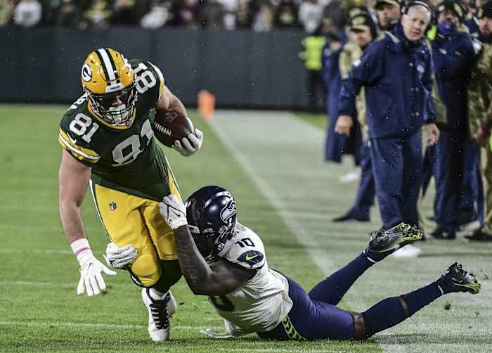 Nov 14, 2021; Green Bay, Wisconsin, USA; Seattle Seahawks linebacker Benson Mayowa (10) drags down Green Bay Packers tight end Josiah Deguara (81) in the fourth quarter at Lambeau Field. Mandatory Credit: Benny Sieu-USA TODAY Sports