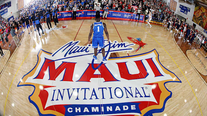Zion Williamson stands in front of the Maui Invitational logo in 2018
