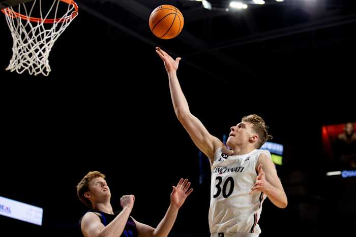 Cincinnati Bearcats forward Viktor Lakhin (30) hits a layup over Presbyterian Blue Hose forward Owen McCormack (15) in the second half of the NCAA men's basketball game on Thursday, Nov. 18, 2021, at Fifth Third Arena in Cincinnati. Cincinnati Bearcats defeated Presbyterian Blue Hose 79-45. Presbyterian Blue Hose At Cincinnati Bearcats 38