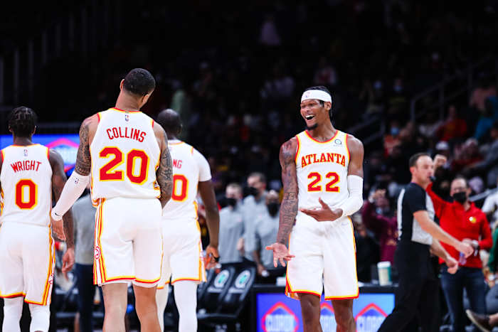 Atlanta Hawks forward John Collins (20) celebrates with forward Cam Reddish (22) during the third quarter against the Detroit Pistons at State Farm Arena.