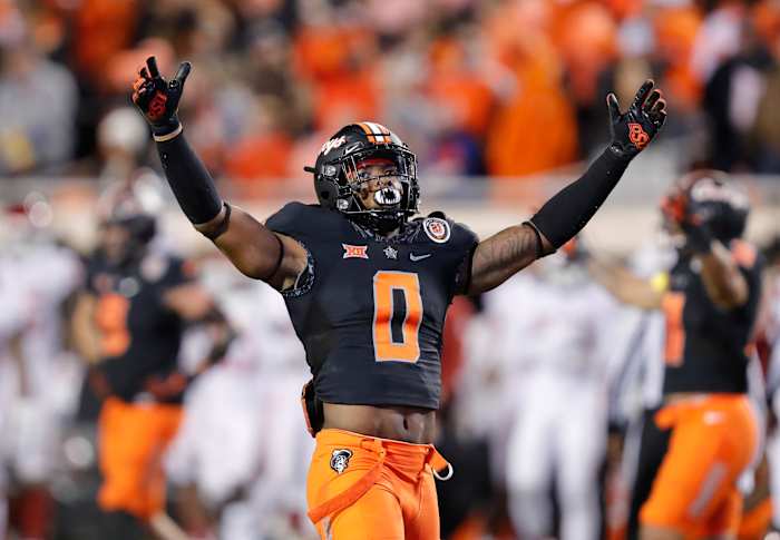 Nov 27, 2021; Stillwater, Oklahoma, USA; Oklahoma State Cowboys cornerback Christian Holmes (0) celebrates after an Oklahoma Sooners tackle during the second half at Boone Pickens Stadium. Oklahoma State won 37-33.