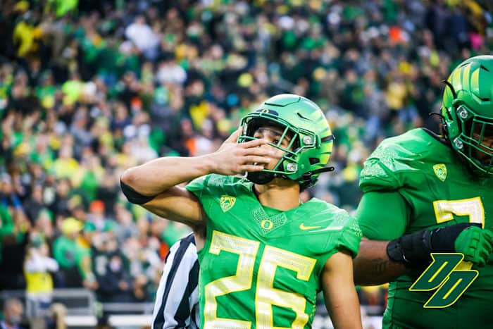 Travis Dye blows a kiss to the crowd as he celebrates a touchdown. 