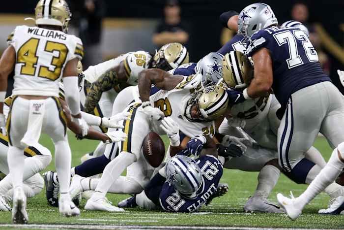 Dallas Cowboys running back Ezekiel Elliott (21) fumbles against the New Orleans Saints. Mandatory Credit: Chuck Cook-USA TODAY Sports