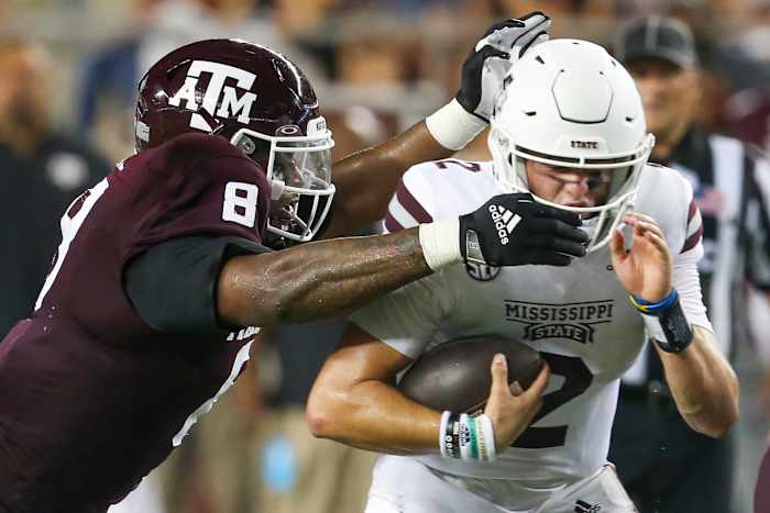 Oct 2, 2021; College Station, Texas, USA; Mississippi State Bulldogs quarterback Will Rogers (2) breaks the tackle of Texas A&M Aggies defensive lineman DeMarvin Leal (8) in the third quarter at Kyle Field.