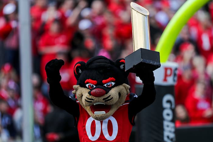 Oct 16, 2021; Cincinnati, Ohio, USA; The Cincinnati Bearcats mascot holds up the College Football Playoff National Championship trophy after a touchdown against the UCF Knights in the first half at Nippert Stadium. Mandatory Credit: Katie Stratman-USA TODAY Sports