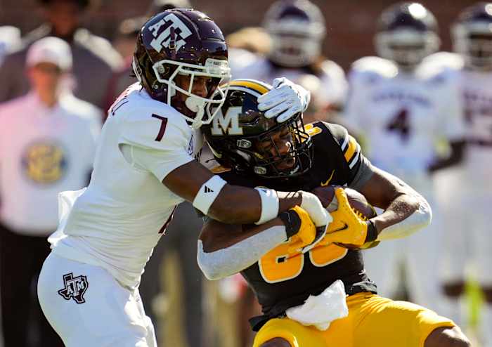 Oct 16, 2021; Columbia, Missouri, USA; Missouri Tigers wide receiver Tauskie Dove (86) is tackled by Texas A&M Aggies defensive back Tyreek Chappell (7) during the first half at Faurot Field at Memorial Stadium.