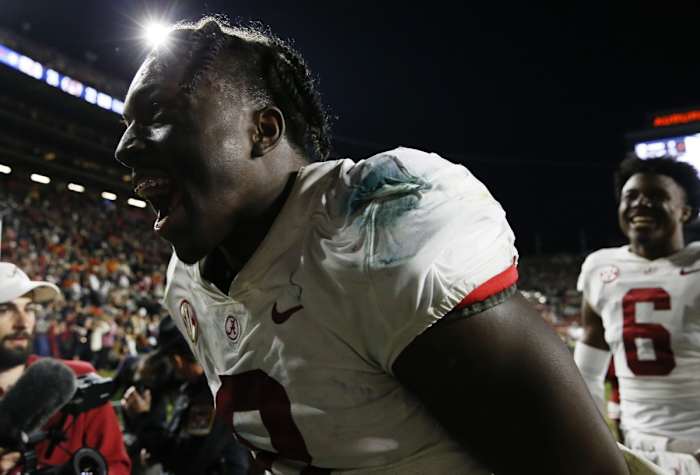 Nov 27, 2021; Auburn, Alabama, USA; Alabama Crimson Tide linebacker Christian Harris (8) celebrates as he leaves the field after defeating the Auburn Tigers at Jordan-Hare Stadium. Alabama defeated Auburn in four overtimes.