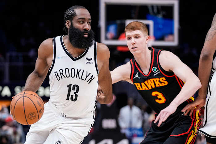 Brooklyn Nets guard James Harden (13) dribbles in front of Atlanta Hawks guard Kevin Huerter (3) during the first half at State Farm Arena.