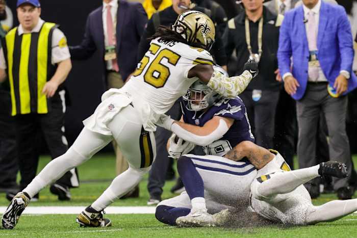New Orleans Saints linebacker Demario Davis (56) tackles Dallas tight end Dalton Schultz (86). Mandatory Credit: Stephen Lew-USA TODAY Sports