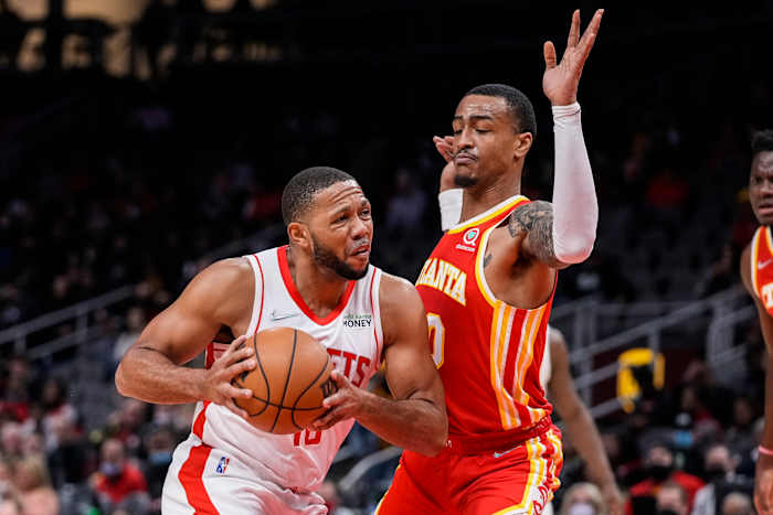 Houston Rockets guard Eric Gordon (10) is defended by Atlanta Hawks forward John Collins (20) during the first half at State Farm Arena.
