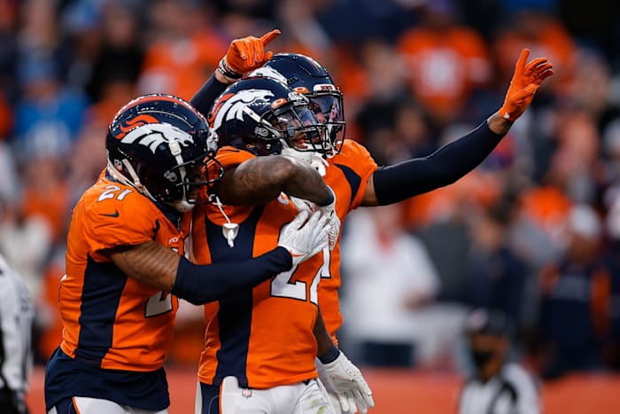 Denver Broncos safety Kareem Jackson (22) celebrates with cornerback Ronald Darby (21) and safety Justin Simmons (31) after a play in the fourth quarter against the Detroit Lions at Empower Field at Mile High.