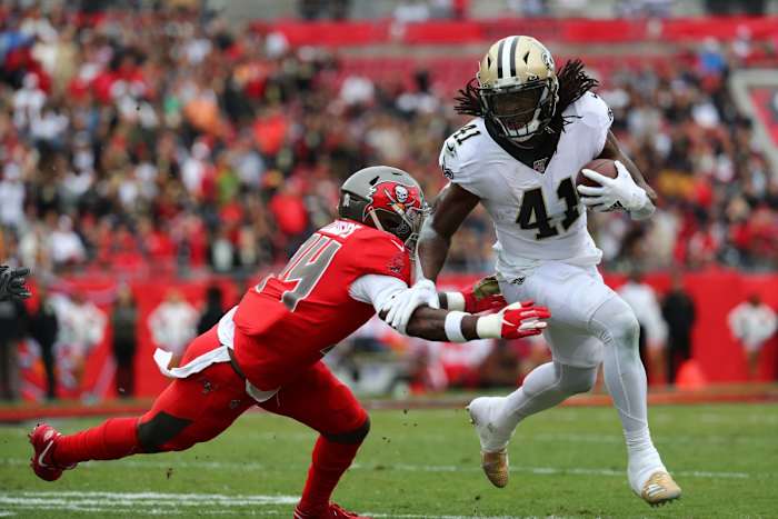 New Orleans Saints running back Alvin Kamara (41) runs past Tampa Bay Buccaneers safety Mike Edwards (34). Mandatory Credit: Kim Klement-USA TODAY Sports