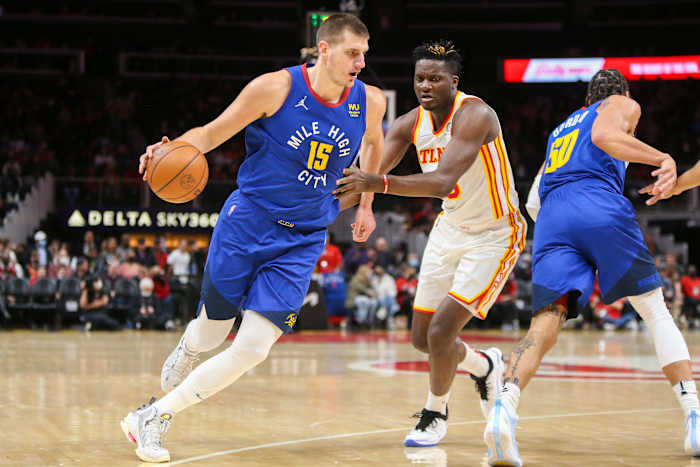 Hawks center Clint Capela defends Nuggets center Nikola Jokic.
