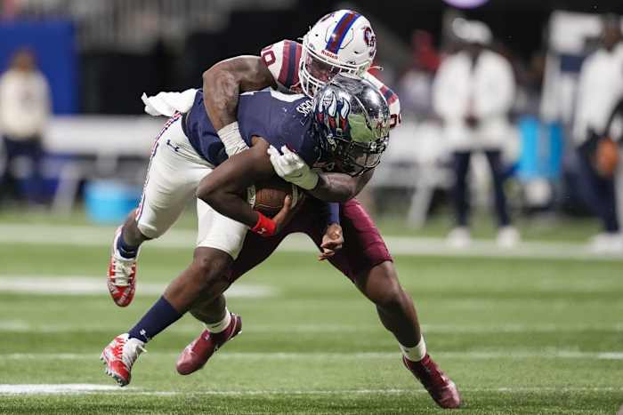 South Carolina State Bulldogs linebacker Aaron Smith (29) tackles Jackson State Tigers quarterback Shedeur Sanders (2)