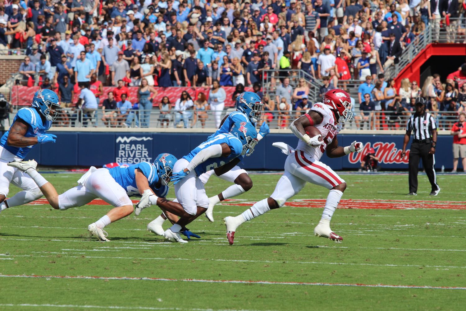 Ole Miss Rebels defense pursuing Arkansas Razorbacks running back Raheim Sanders (2021).