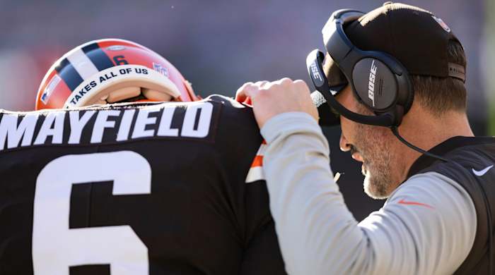Cleveland Browns head coach Kevin Stefanski talks with quarterback Baker Mayfield (6) during the first quarter against the Baltimore Ravens at FirstEnergy Stadium.