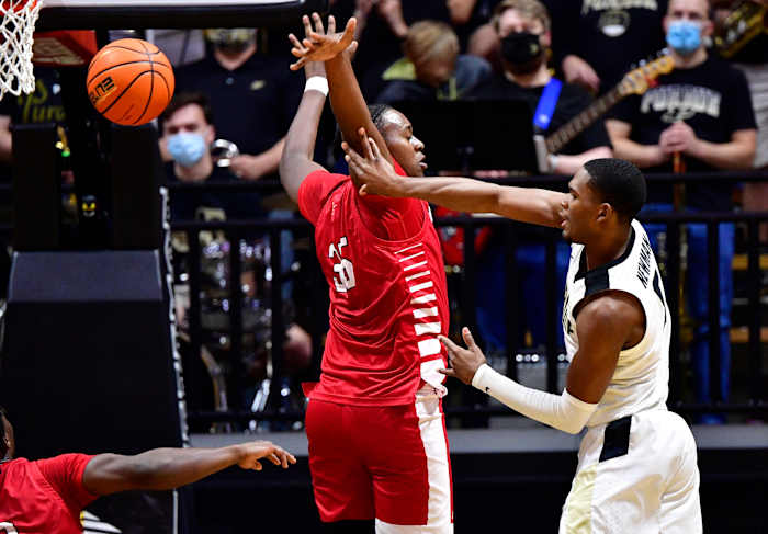Brandon Newman passes the ball around a Nicholls State center.