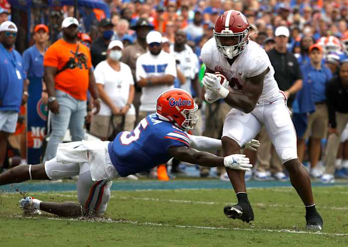 Sep 18, 2021; Gainesville, Florida, USA; Alabama Crimson Tide running back Brian Robinson Jr. (4) runs the ball in for a touchdown as Florida Gators cornerback Kaiir Elam (5) attempts to defend during the first half at Ben Hill Griffin Stadium. Mandatory Credit: Kim Klement-USA TODAY Sports